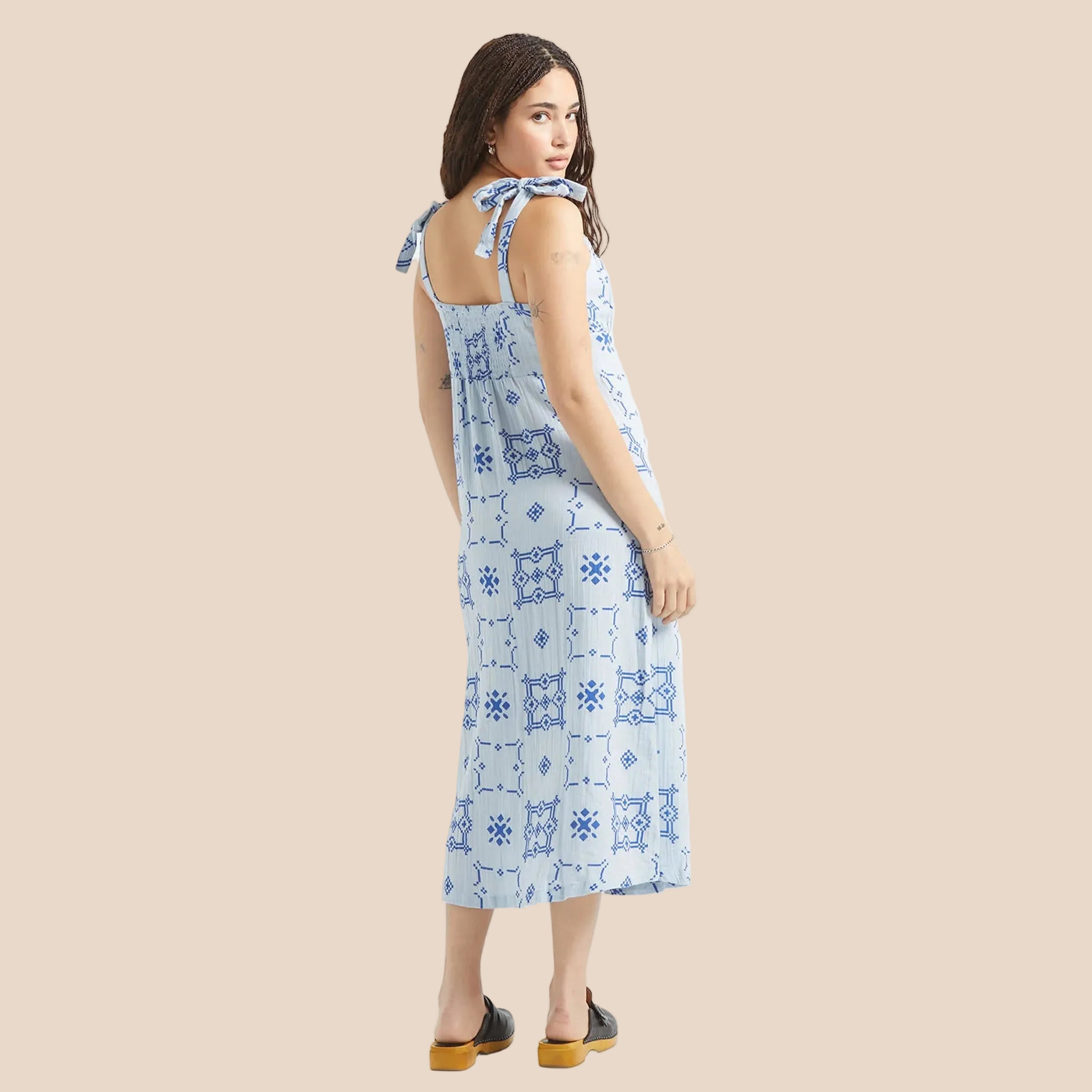 A light blue dress with dark blue tile shaped graphics. 