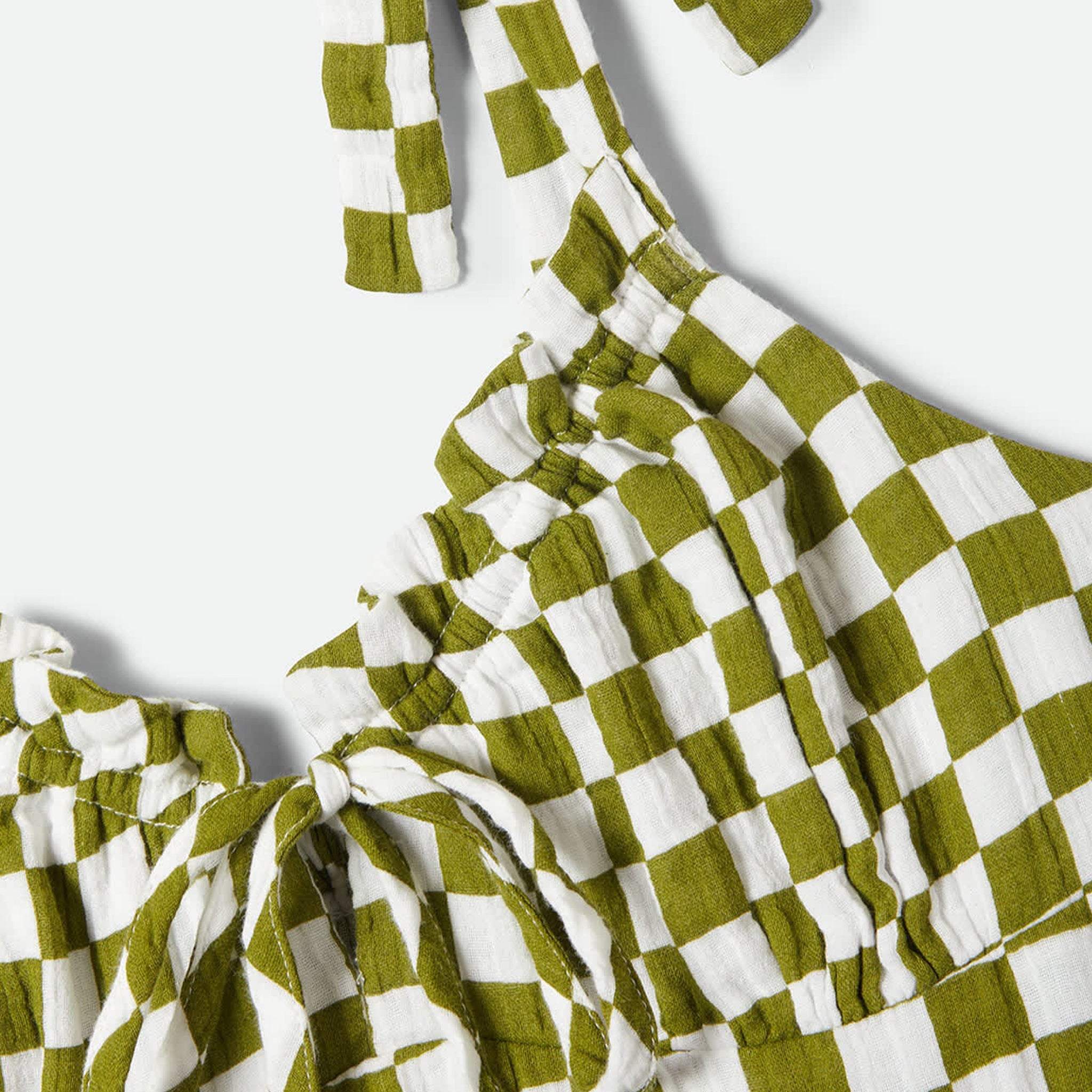 A green and cream checkered tie dress. 