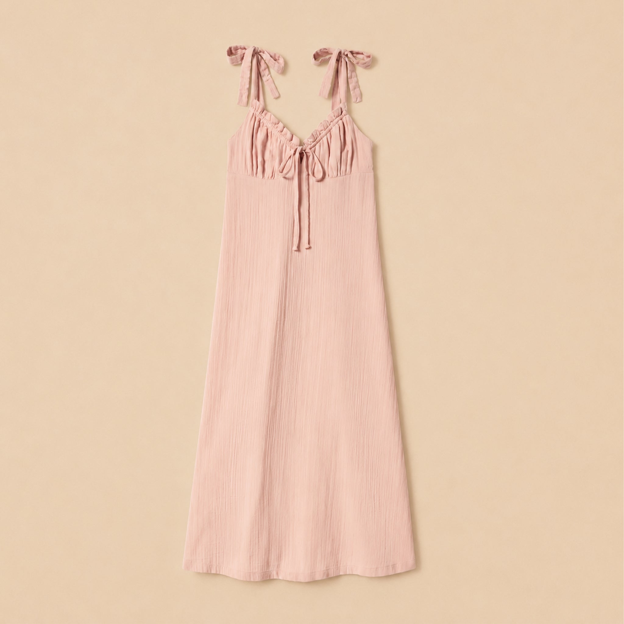 Pink dress against a beige background