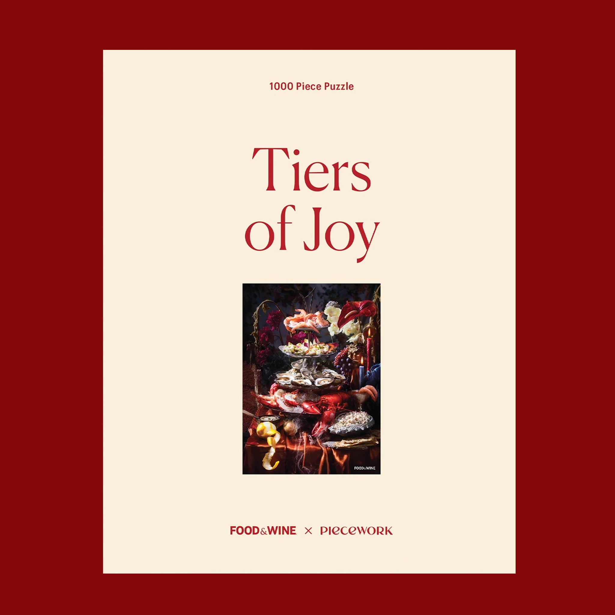 A 1000 piece puzzle box with a photo of the completed puzzle that  depicts a silver tiered tray filled with shrimps, oysters, lobster and lemons surrounded by dramatic florals and candle sticks. "1000 Piece Puzzle Tiers of Joy Piecework Puzzles".