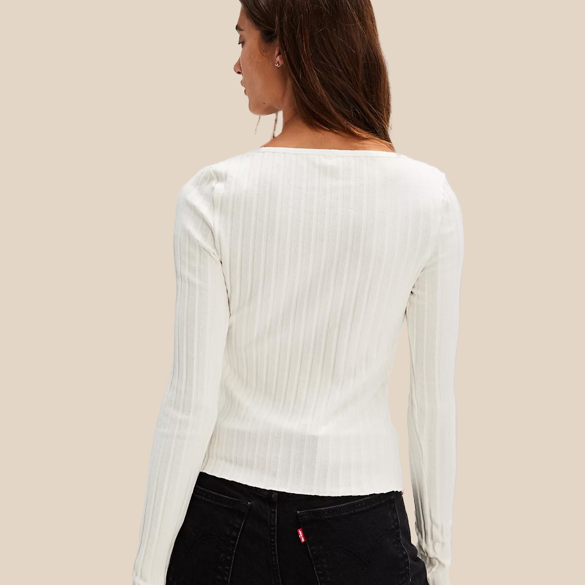 A white ribbed shirt with a button closure. 