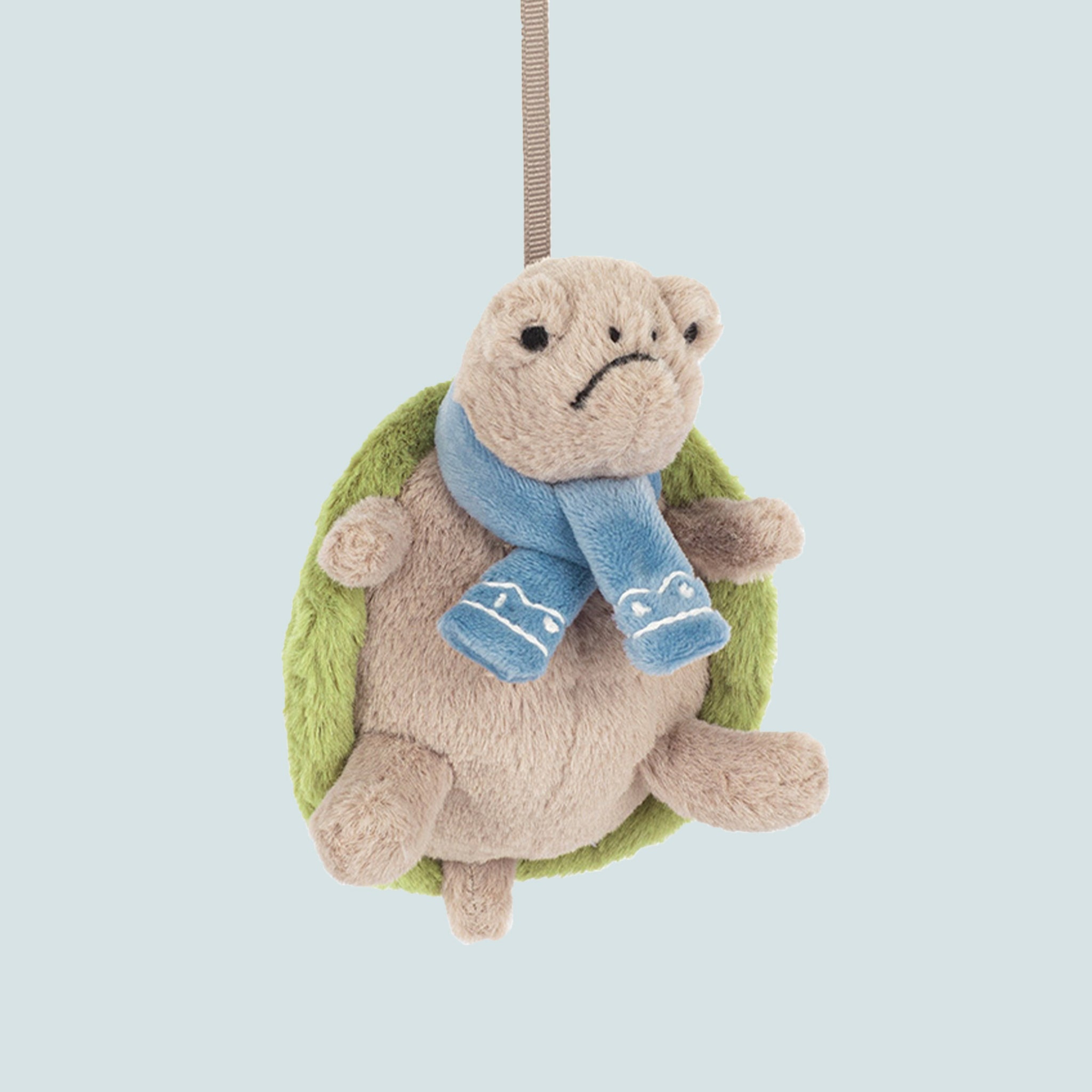 A turtle shaped ornament wearing a scarf. 
