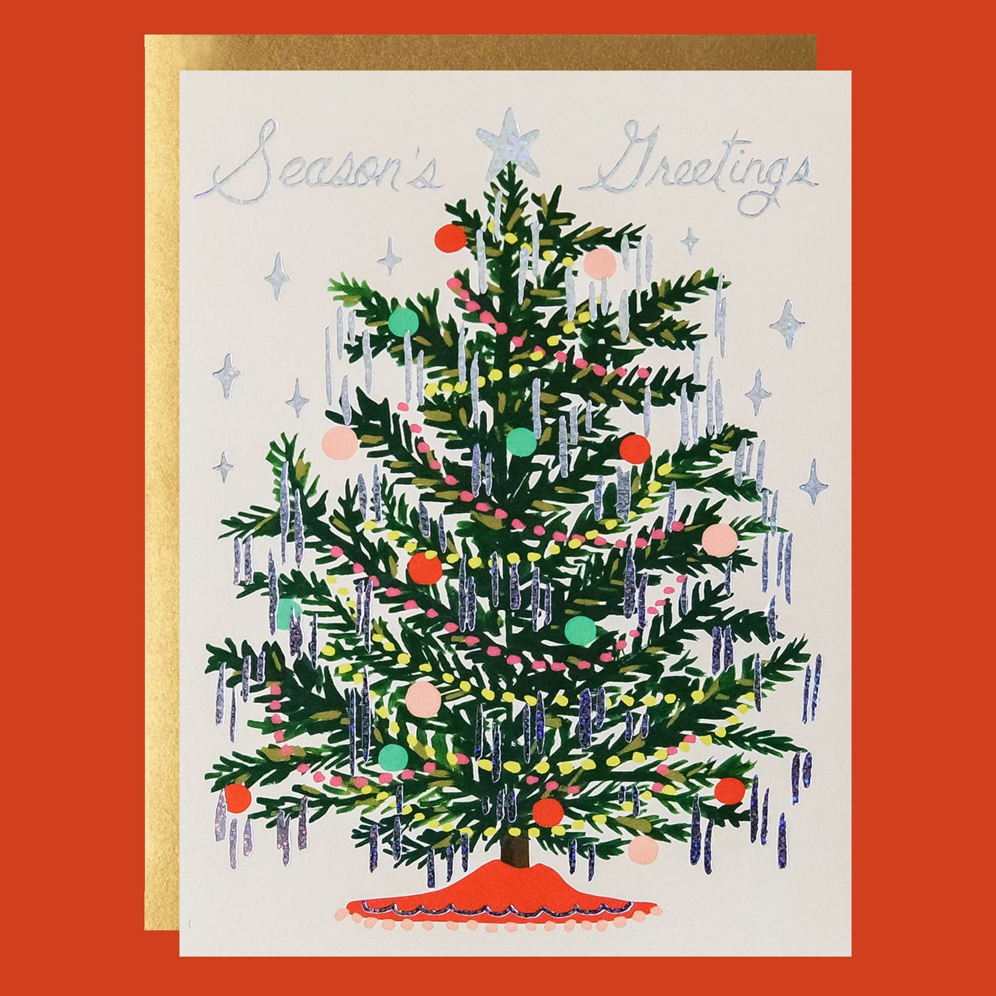 Cream colored greeting card with a green Christmas tree on it. The tree is decorated with multi colored ornaments and holographic tinsel. The card reads, "Season's Greetings" and has a holographic silver star at the top of the tree. 