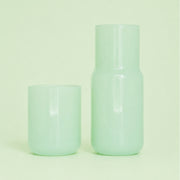 A light green glass carafe. 