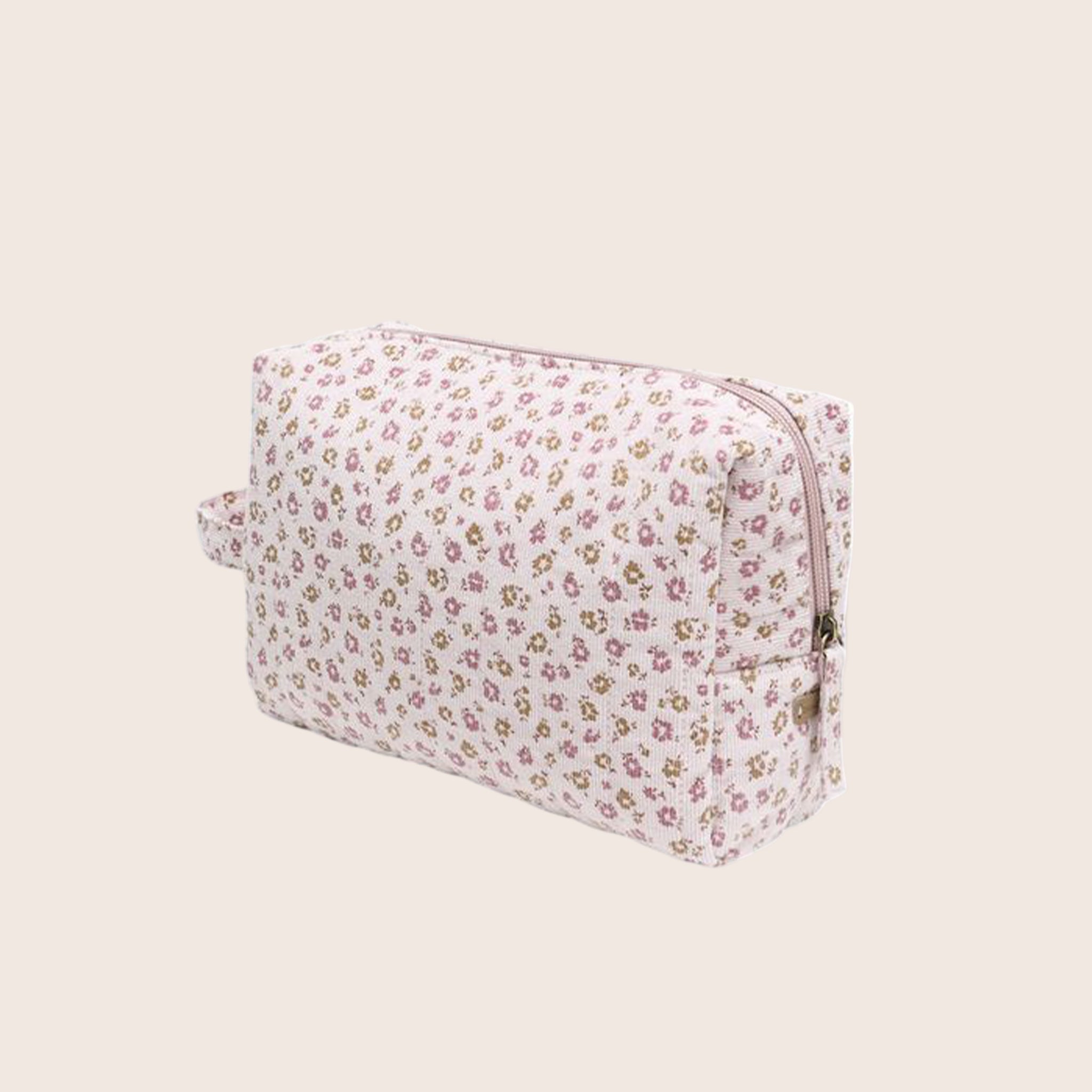 A toiletry bag with a light pink floral print. 