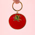 A tomato shaped enamel keychain. 