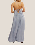 A light blue maxi dress with a lace detail and spaghetti straps with a low back. 