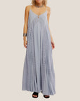 A light blue maxi dress with a lace detail and spaghetti straps with a low back. 