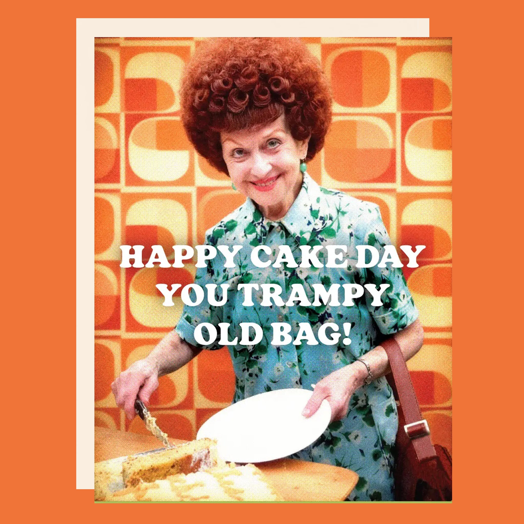 Greeting card with a woman cutting a cake. The card reads "Happy cake day you trampy old bag!"