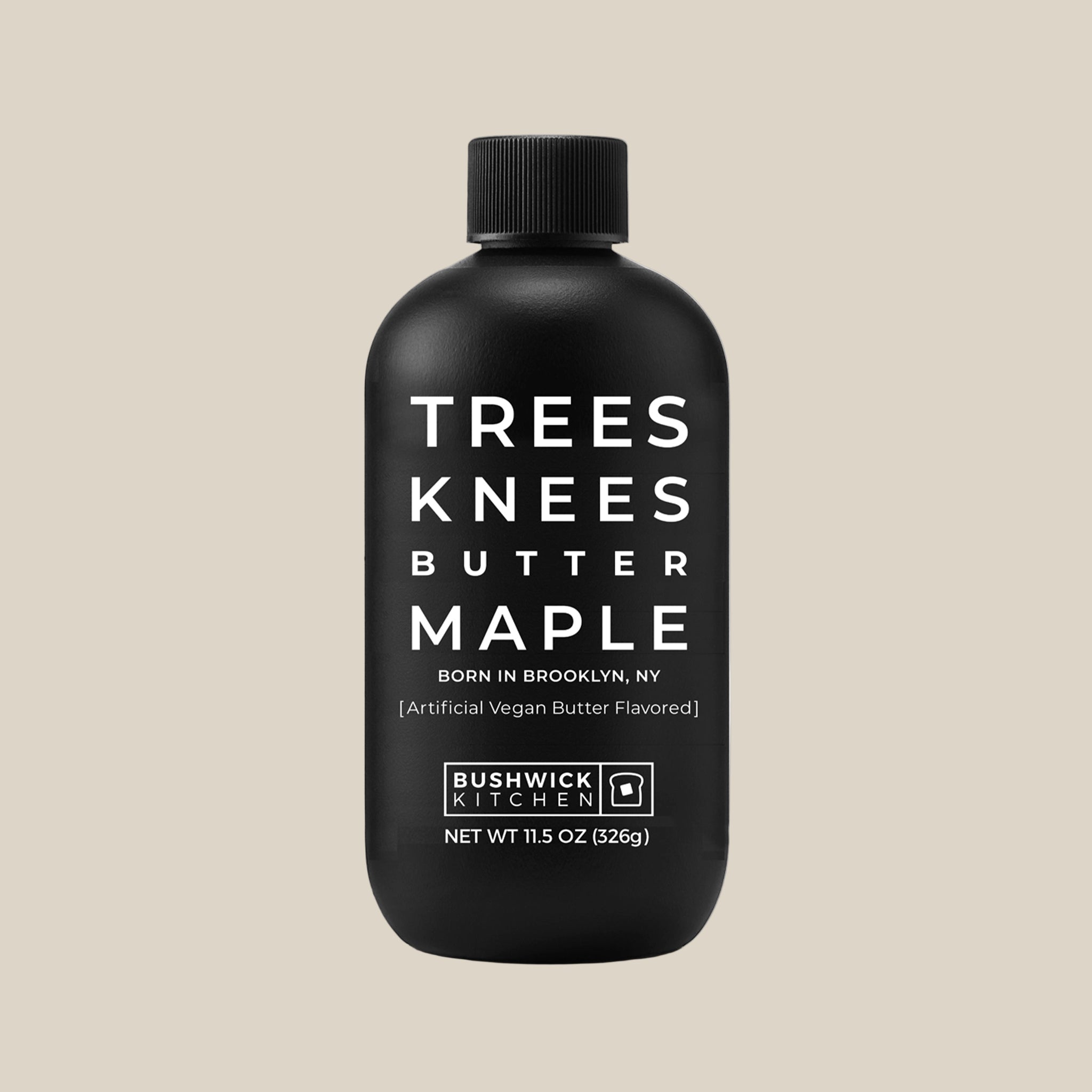 A black bottle of syrup with text on the front that reads, 'Tree Knees Butter Maple'. 