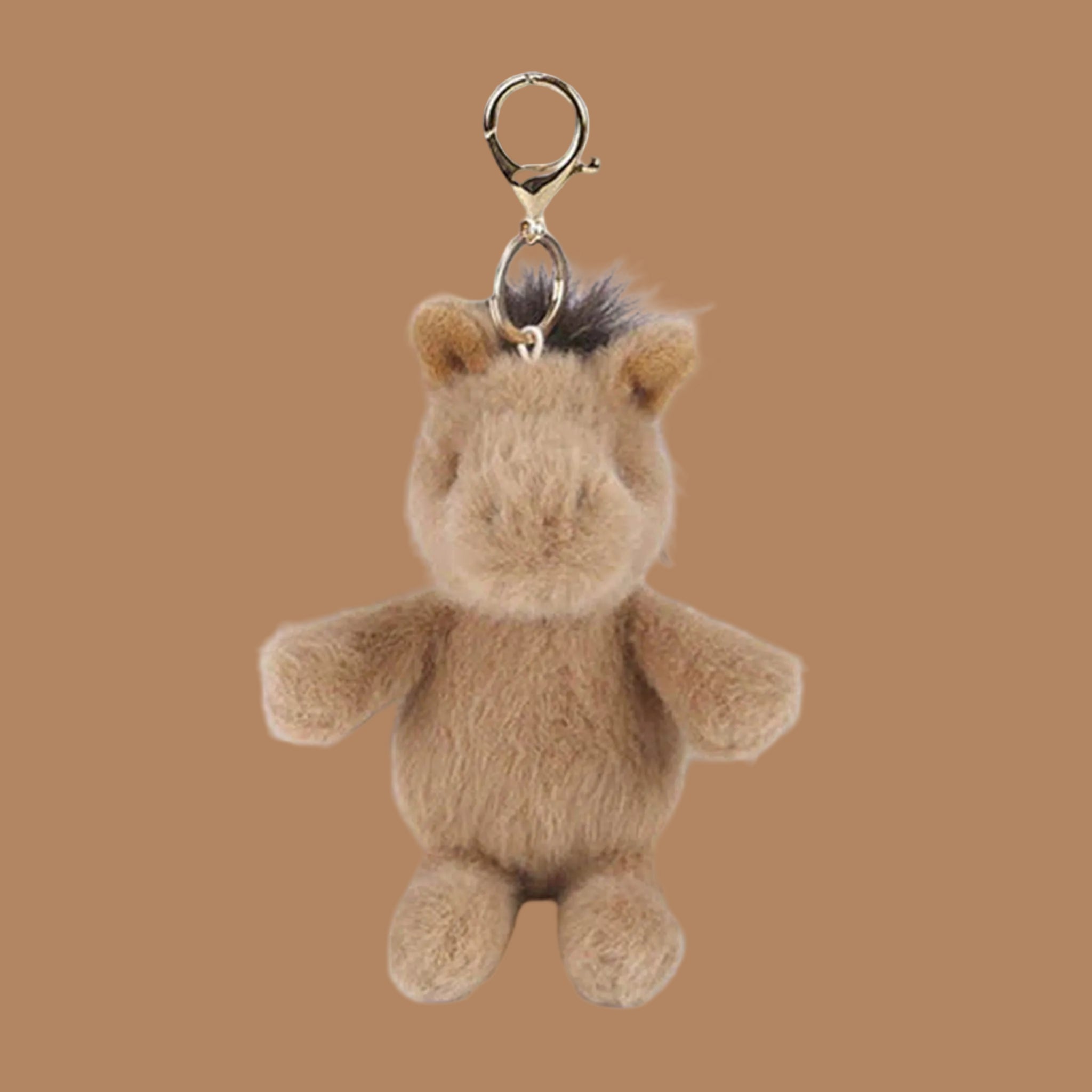 A brown horse shaped bag charm. 