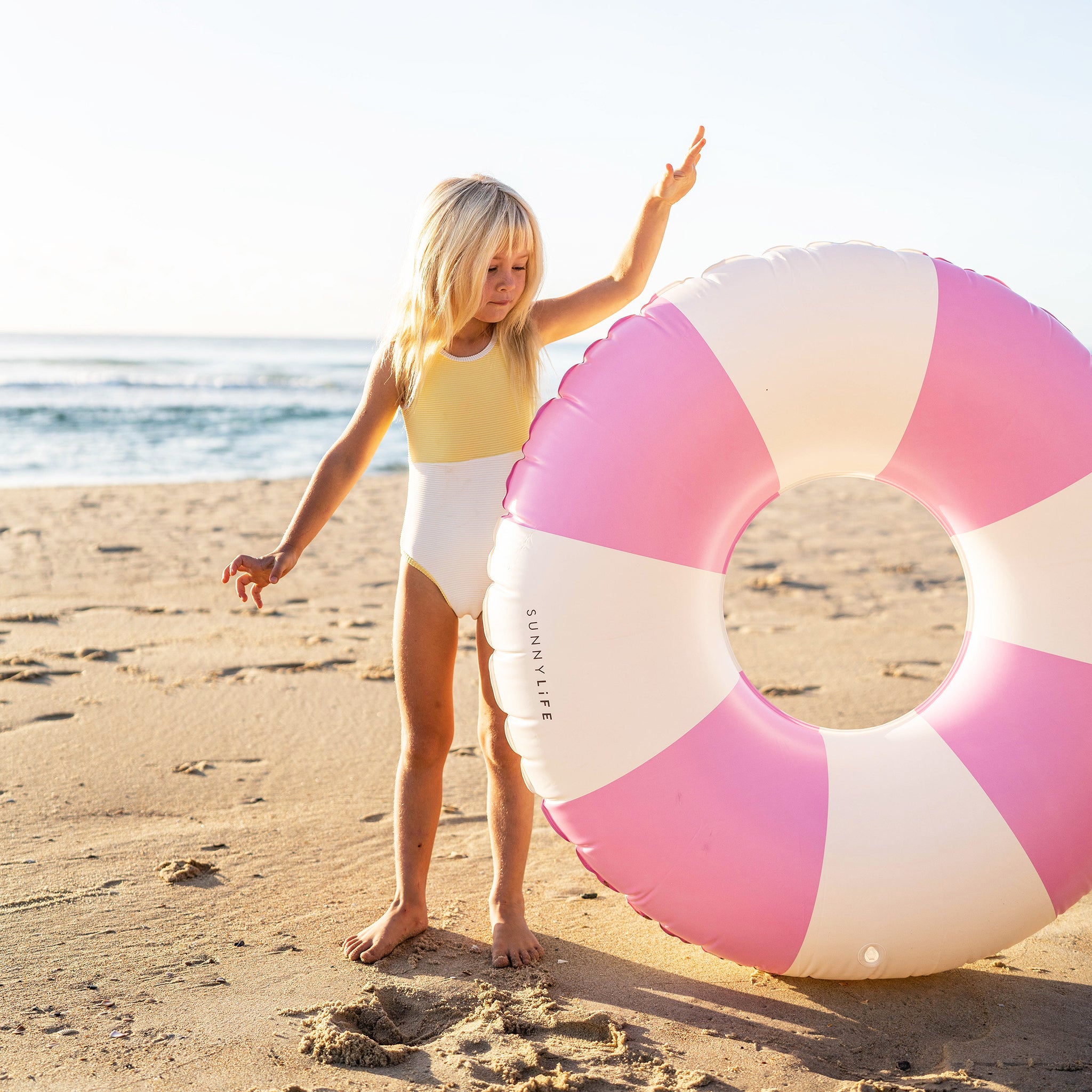 A pink and white pool ring float.