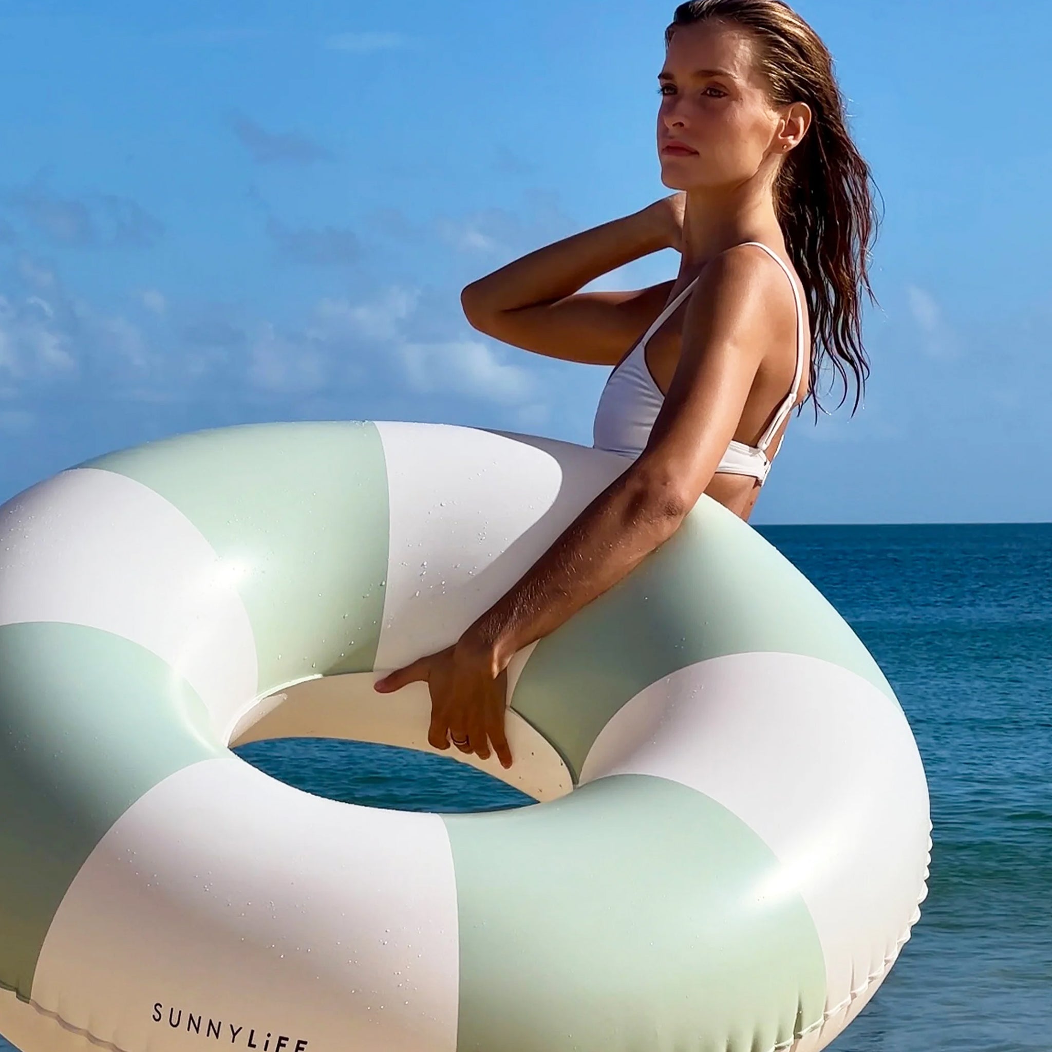 A white and mint round tube inflatable float. 