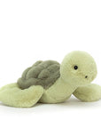On a white background is a light green turtle stuffed animal. 