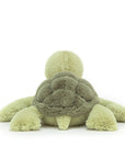 On a white background is a light green turtle stuffed animal.