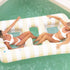 A two person ivory and light yellow striped pool float with a mesh loining and cup holders. 