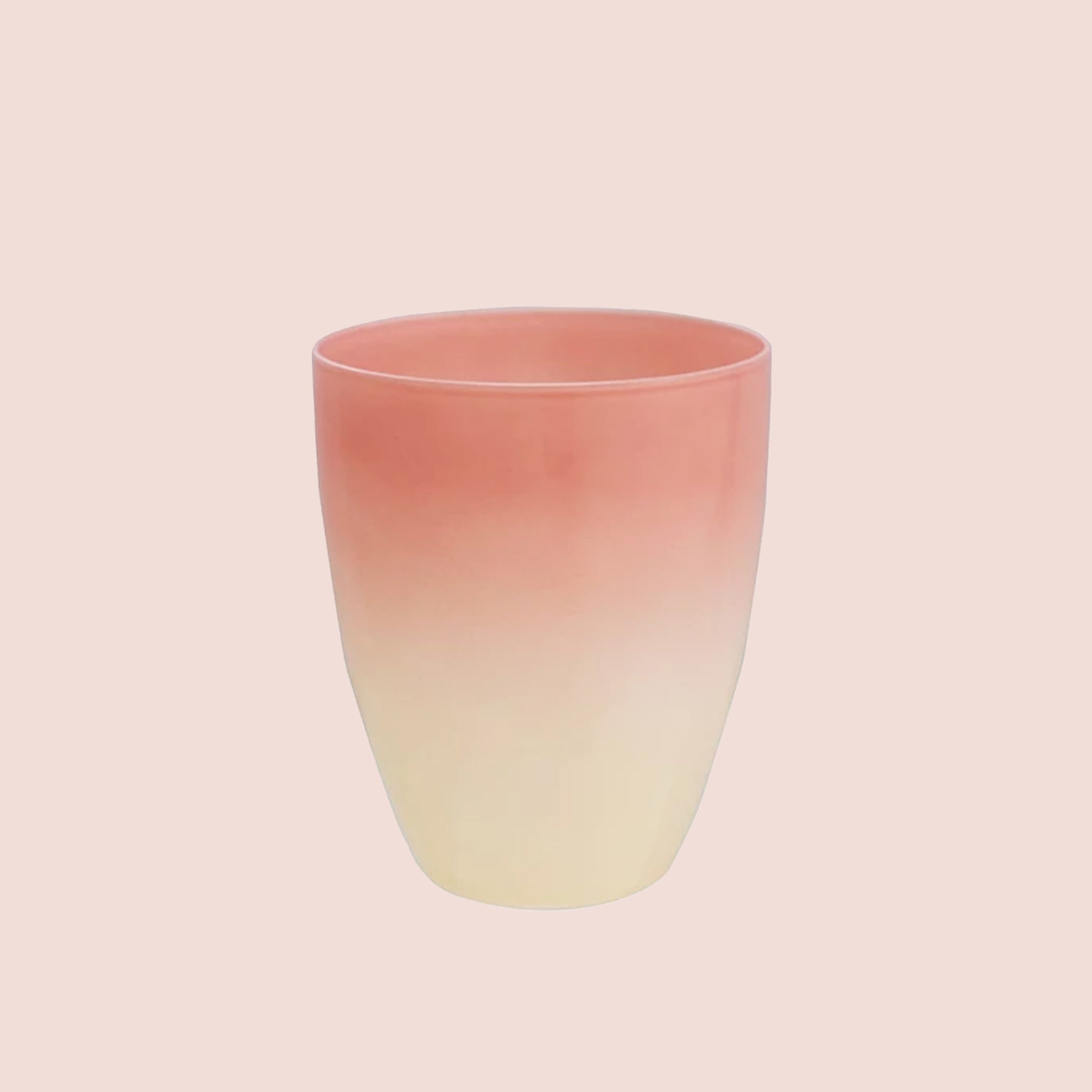 A pink and cream colored cup. 