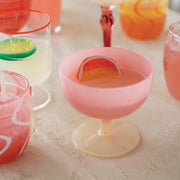 A pink and cream two toned wine glass.