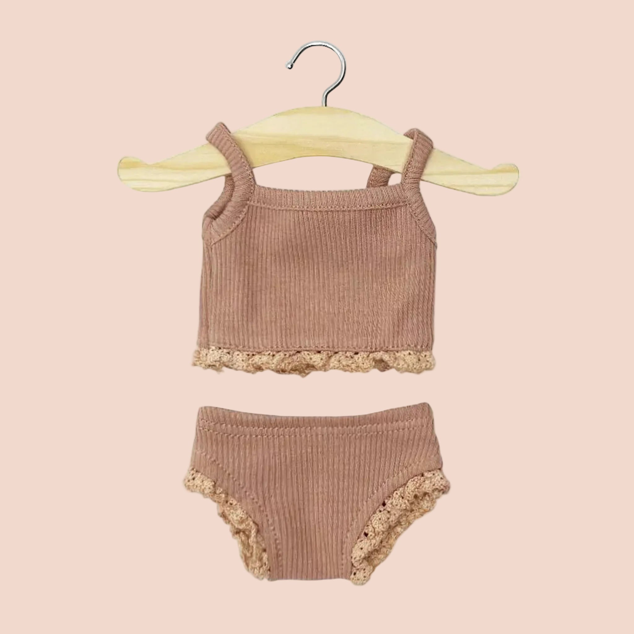 A mauve Minikane doll set. 