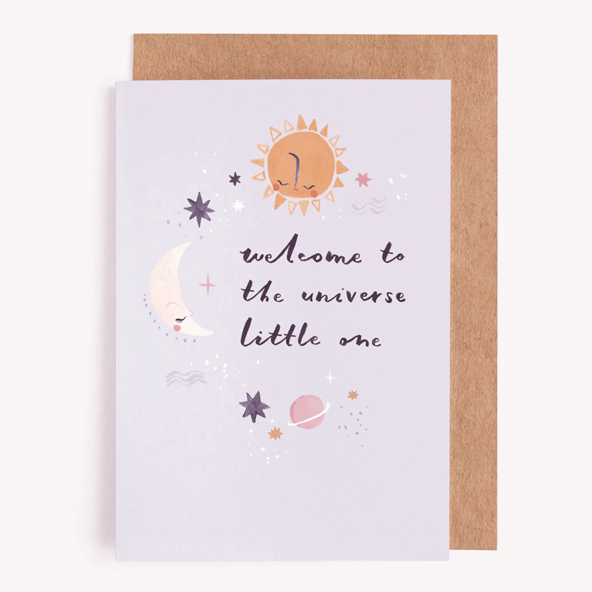 On a white background is a light blue card with illustrations of a sun, moon, and stars along with cursive text that reads, &quot;welcome to the universe little one&quot;. 