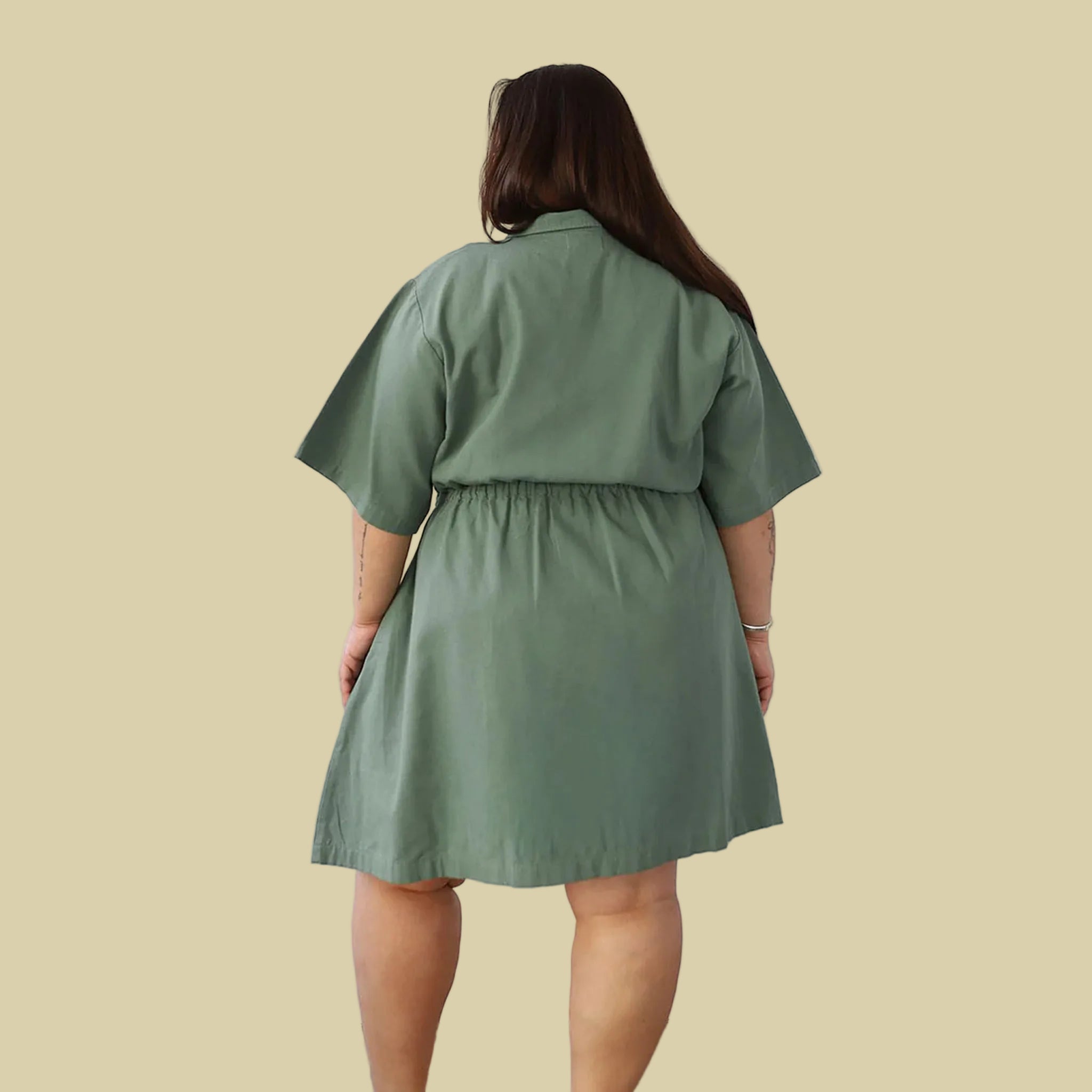 A sage green short utility dress. 