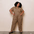 A leopard print utility jumpsuit with short sleeves, a collar and a zipper down the front. 