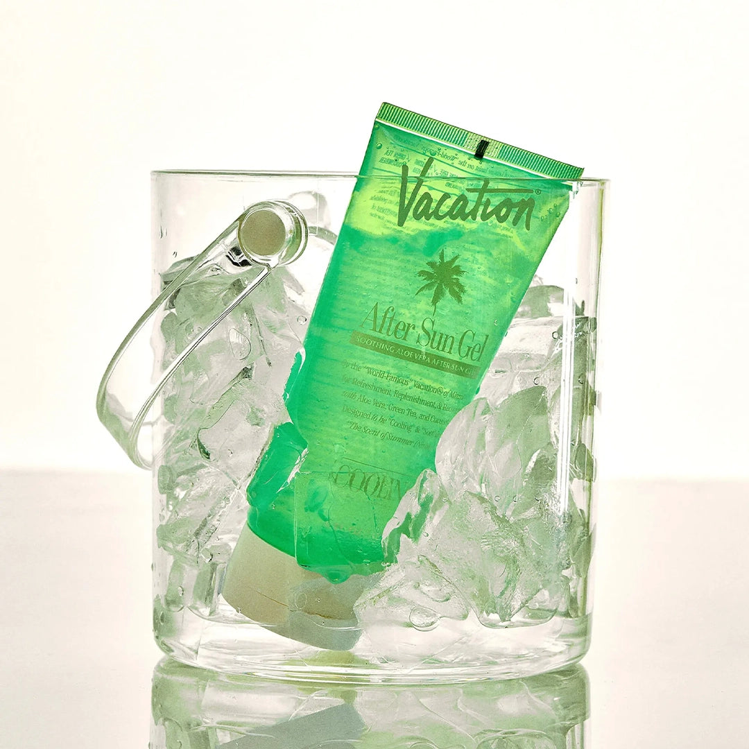 A green bottle of after sun aloe gel with white text and an ivory squeeze tube top. 