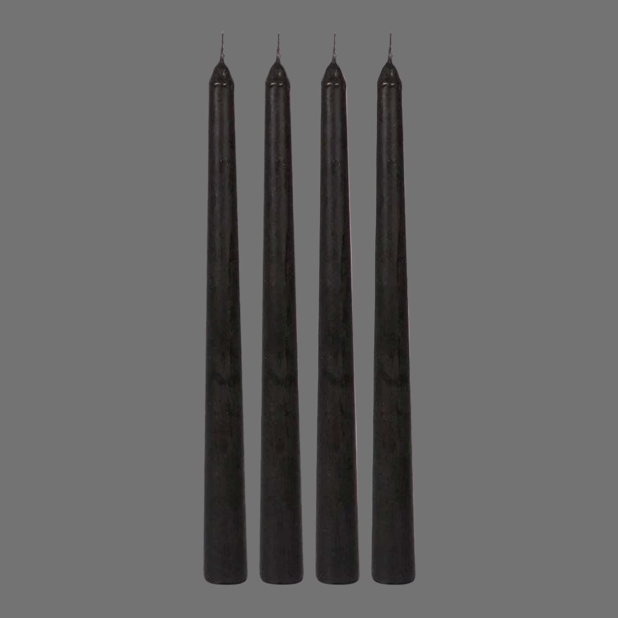 A set of four black taper candles with with dark pinkish purple wax that drips when the candles are lit. 