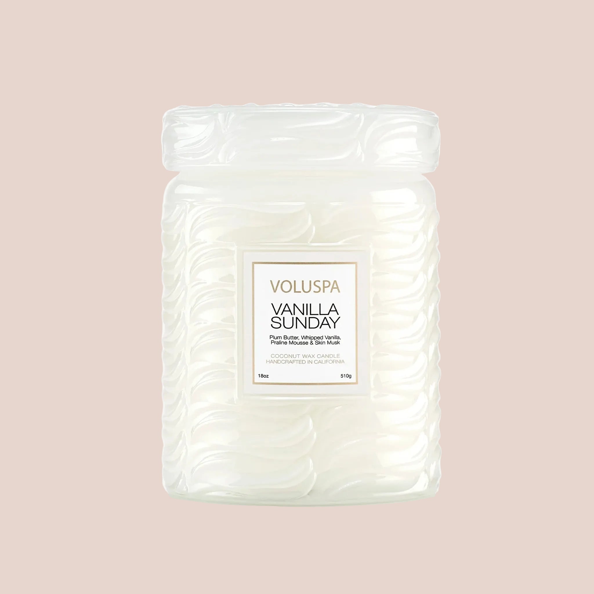 A white large jar glass candle with a rectangle label that reads, "Voluspa Vanilla Sunday". 