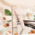 A neutral tan colored tube of lip butter with text that reads, 'Vanilla Almond Butter Smoothie'. 