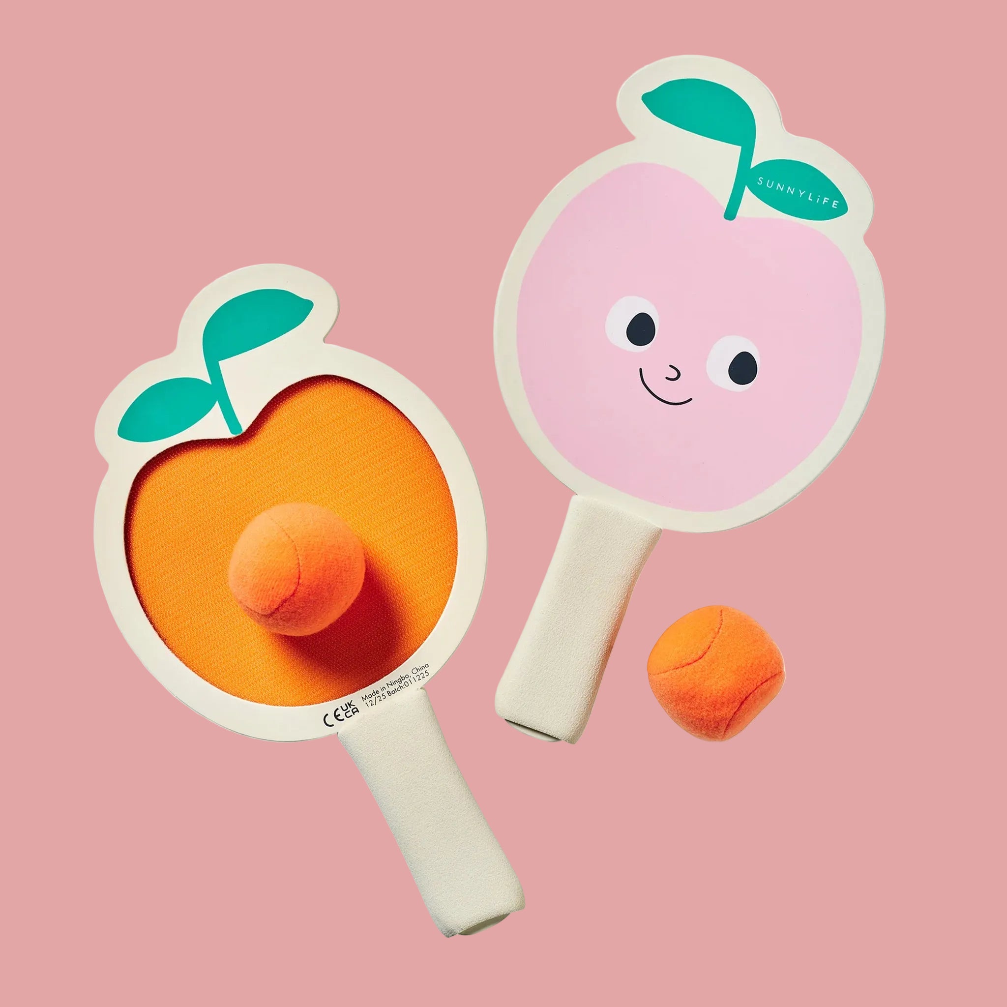 Two peach shaped paddle beach velcro bat toys with a orange ball. 