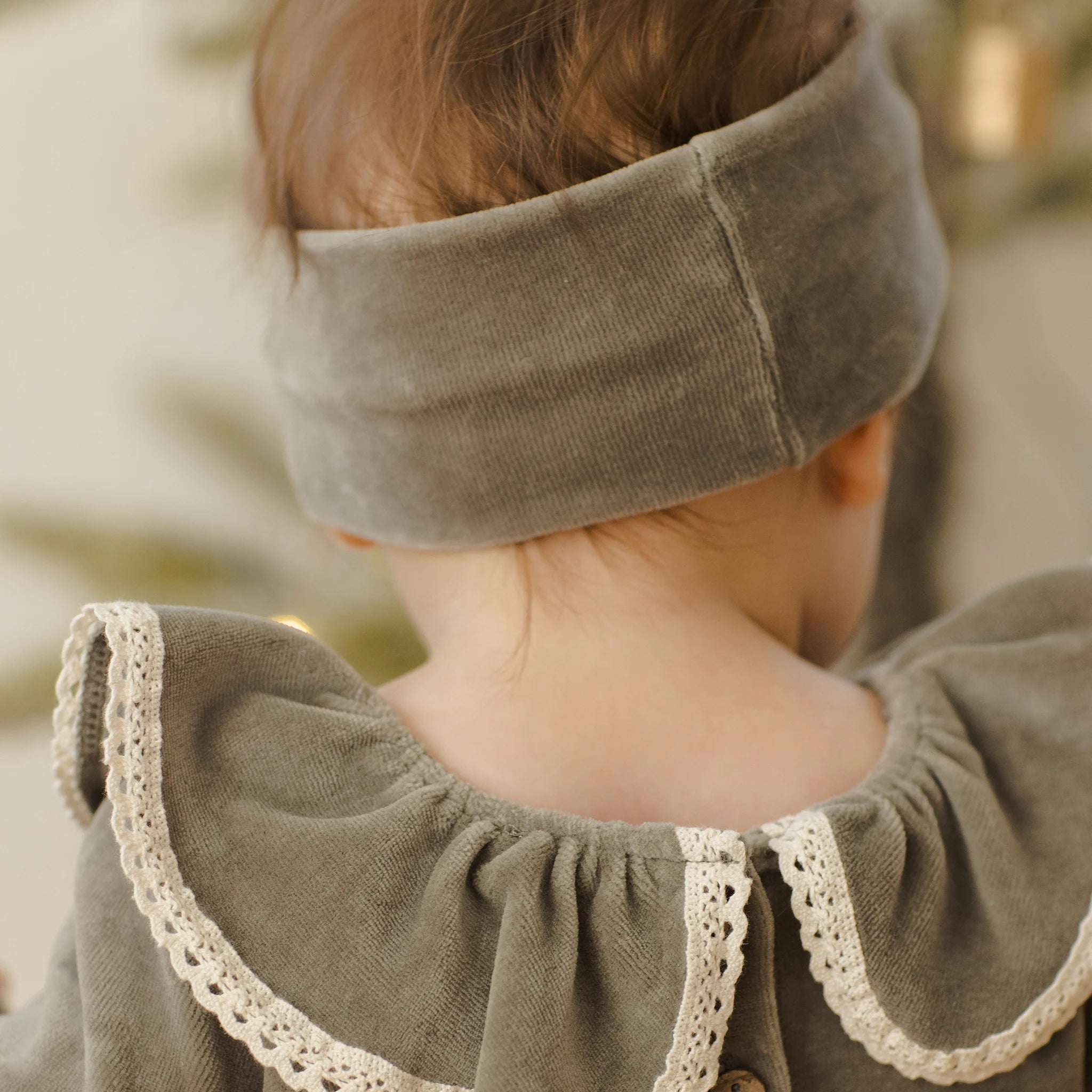A velour green bow headband. 