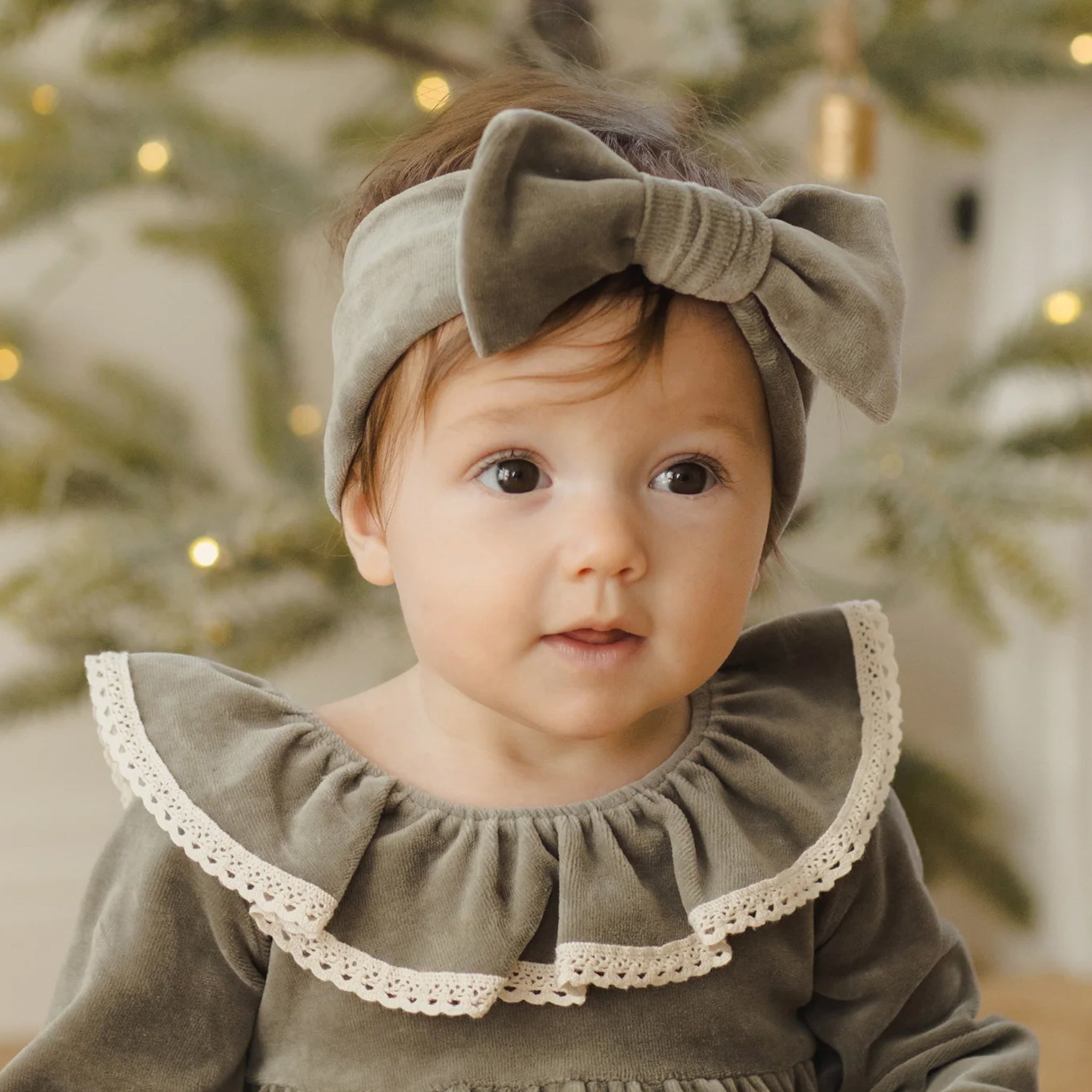 A velour green bow headband. 