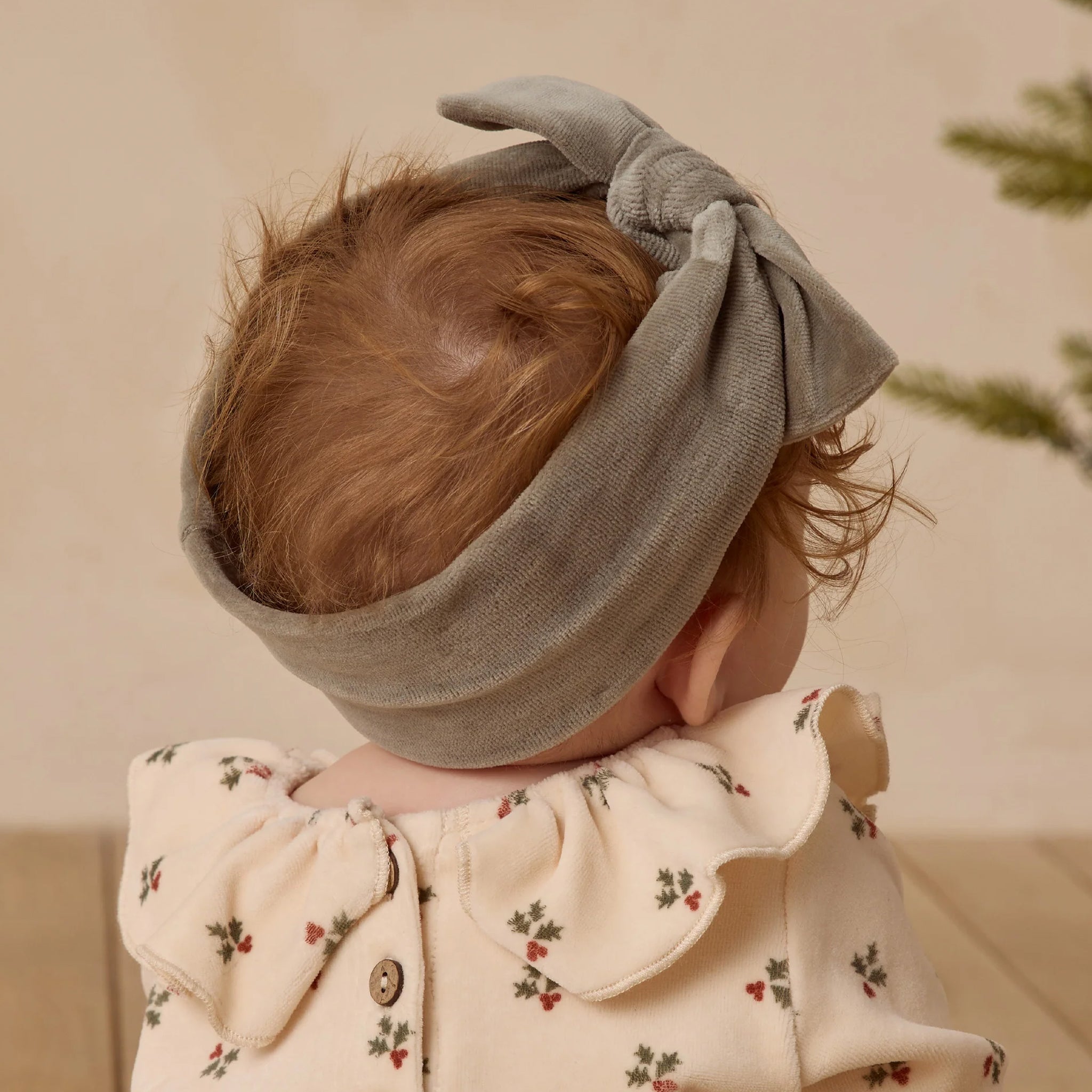 A velour green bow headband. 