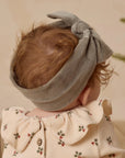 A velour green bow headband. 