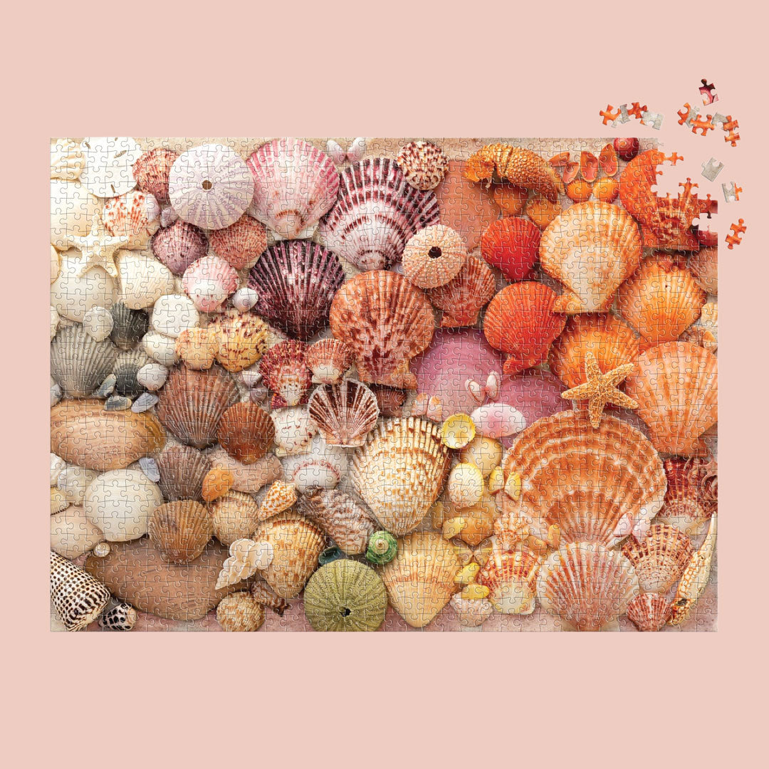 On a peachy background is a puzzle with multi colored seashells. 
