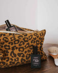 A brown leopard print canvas cosmetic pouch. 