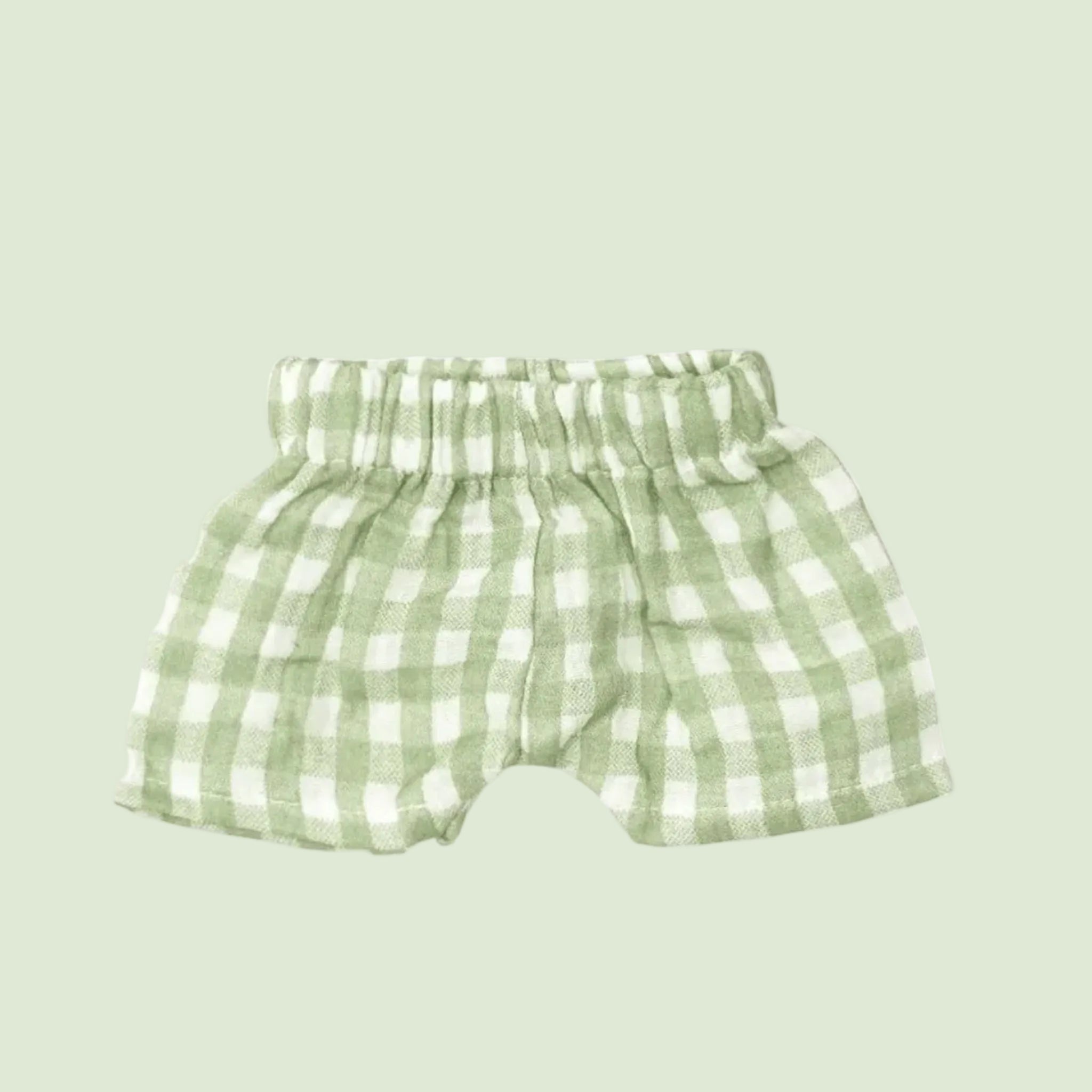 A green pair of gingham print shorts. 