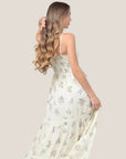 An ivory maxi dress with a neutral floral print with a twisted neckline. 