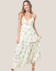An ivory maxi dress with a neutral floral print with a twisted neckline. 