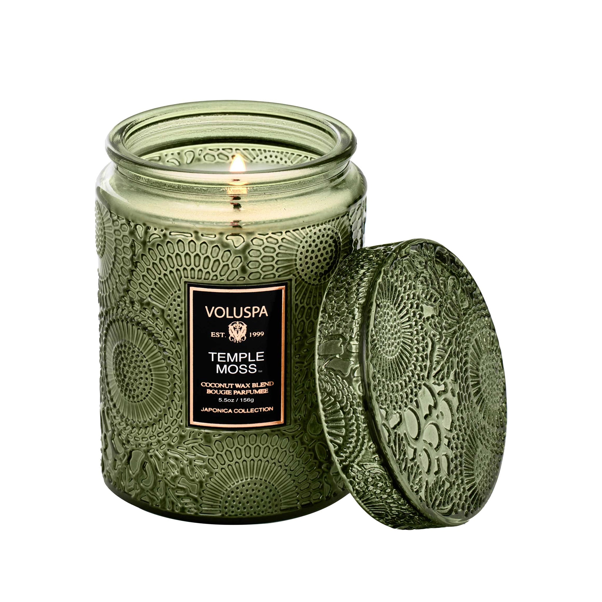 On a white background is a green decorative jar candle with a black label in the center that reads, "Voluspa Temple Moss".