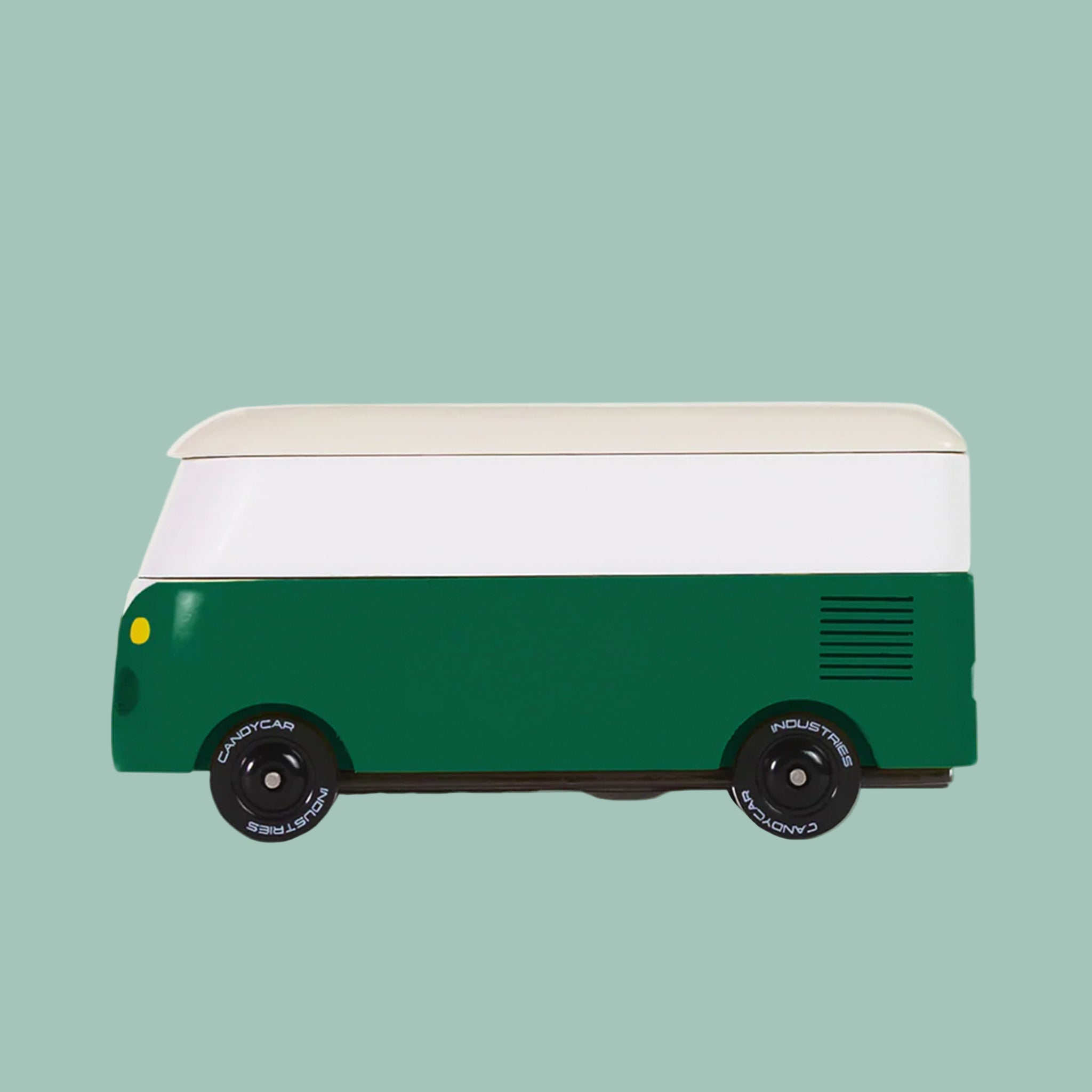 A green and white wooden VW bus toy. 