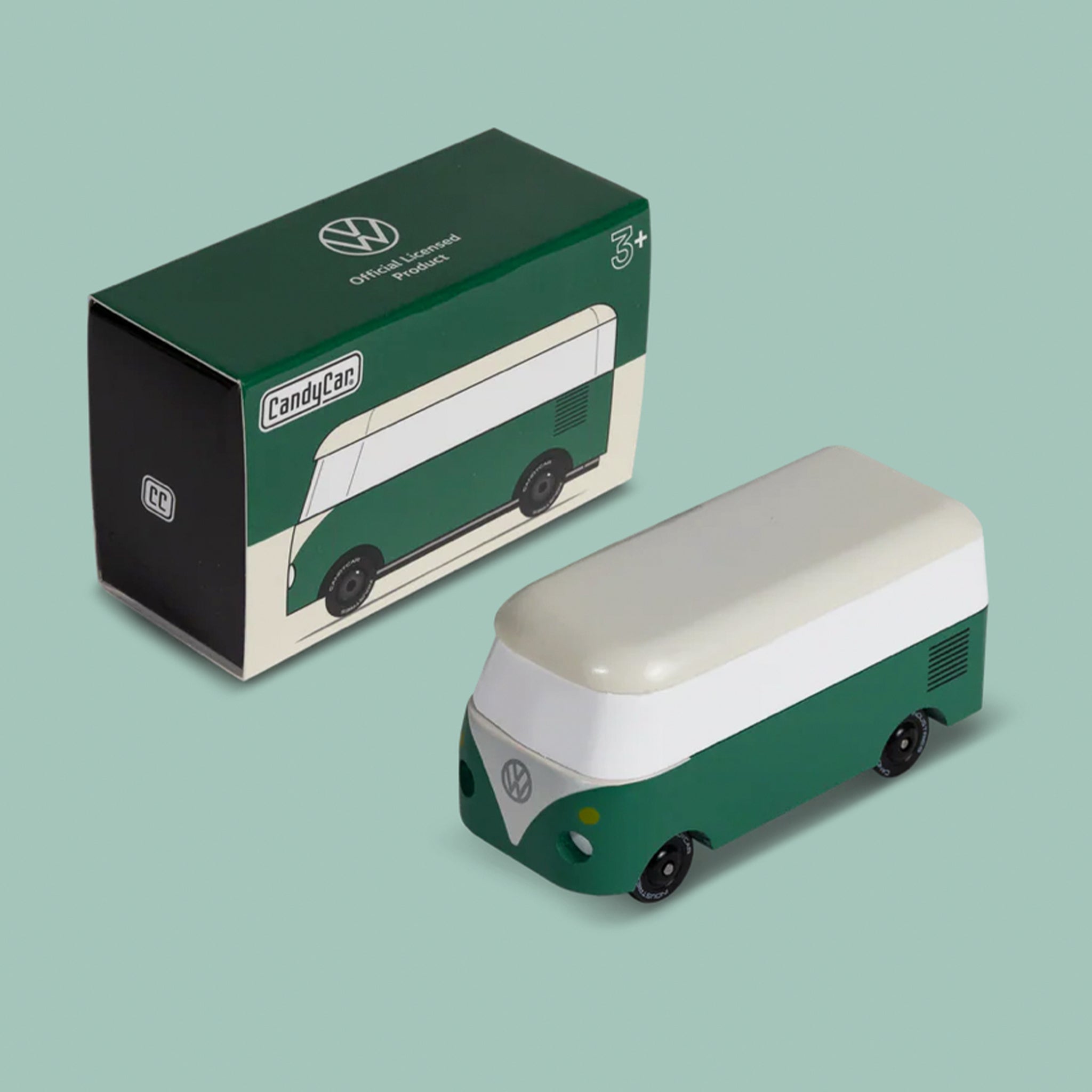 A green and white wooden VW bus toy. 