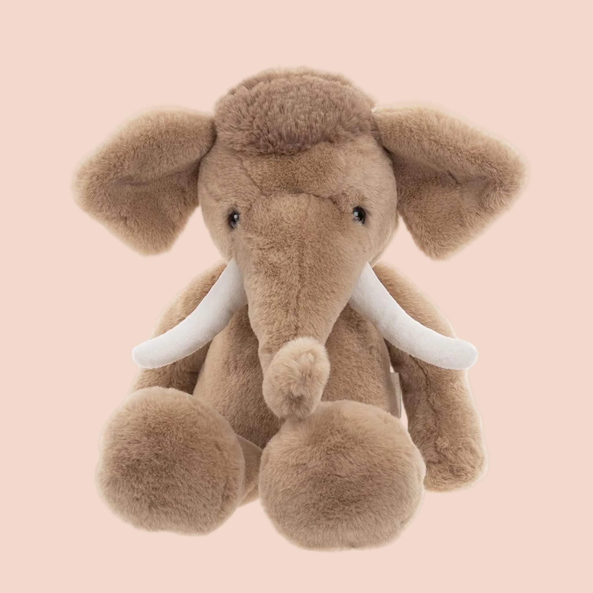 A mammoth shaped stuffed animal toy. 