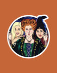 A round sticker with a graphic of the Sanderson sisters from Hocus Pocus.