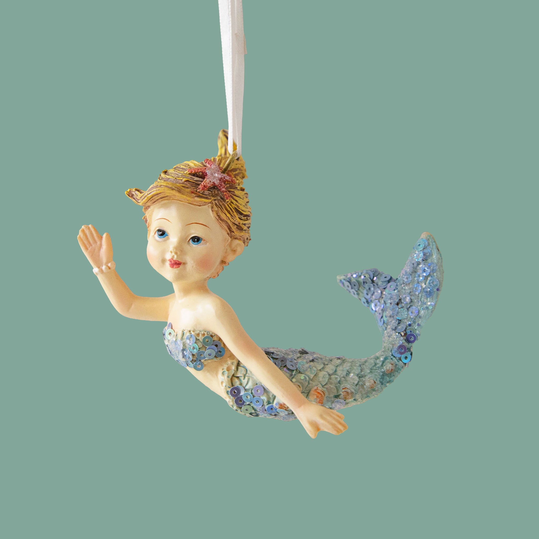 A mermaid shaped ornament that is waving. 