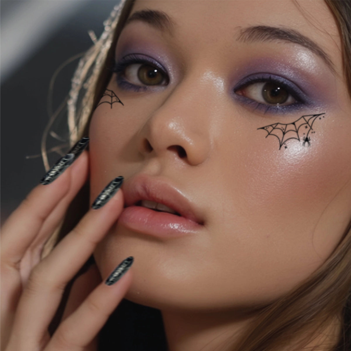 A model wearing the spider web eye patch speckles. 