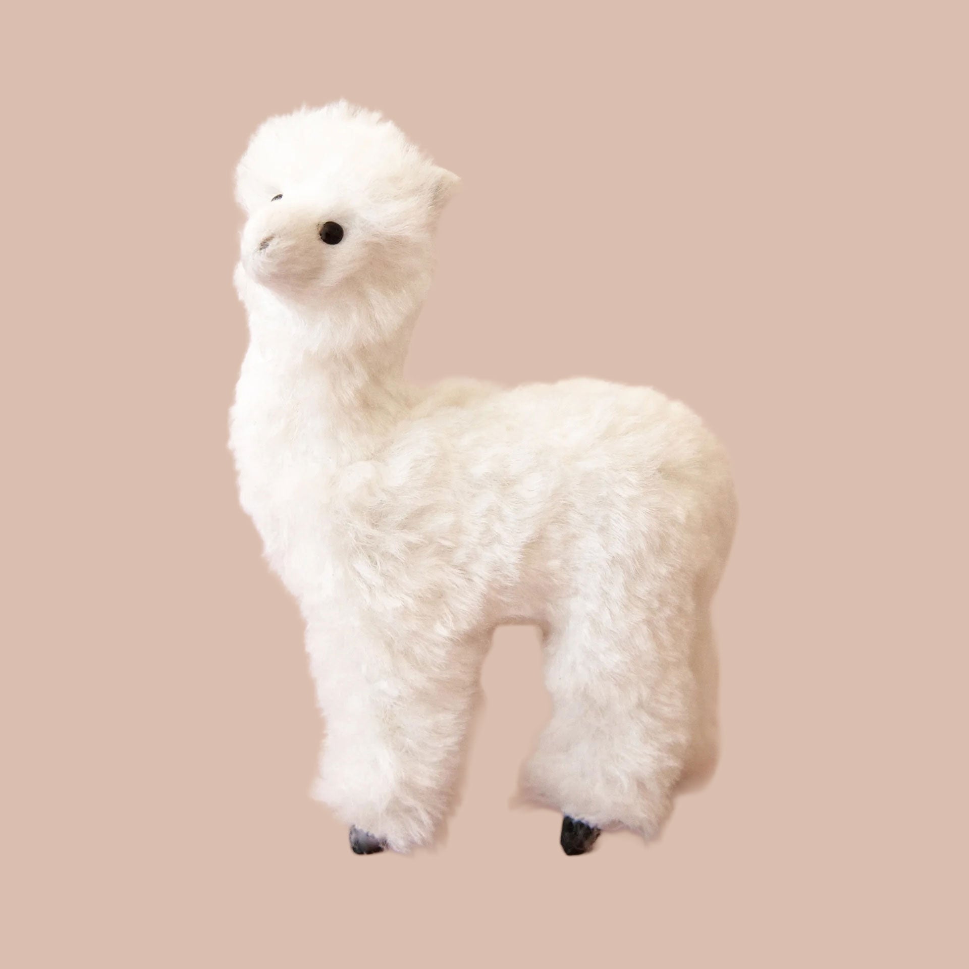 A white fluffy alpaca shaped ornament. 