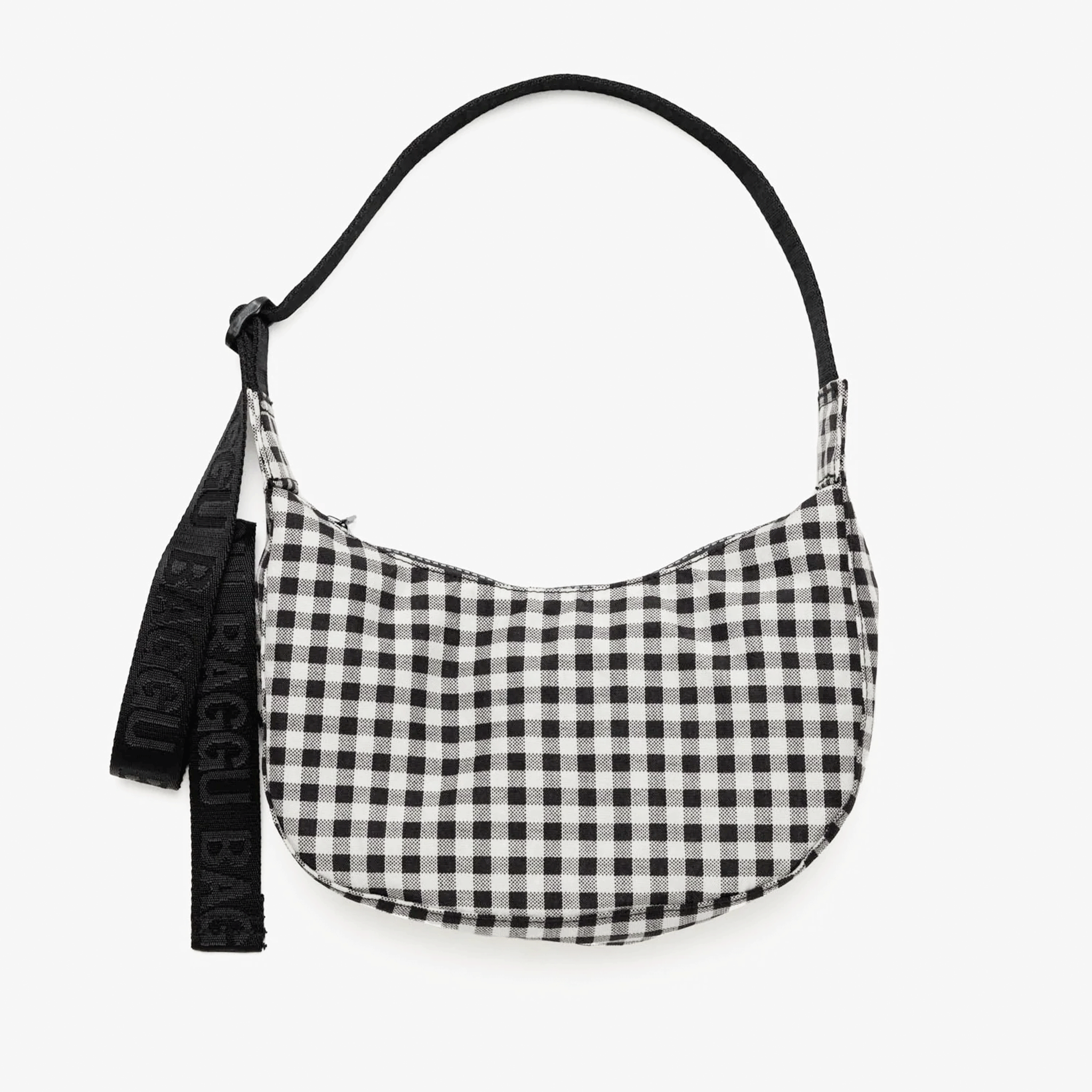 A black and white gingham printed crescent shaped nylon handbag with a black adjustable strap that can go from a shoulder bag to crossbody. 