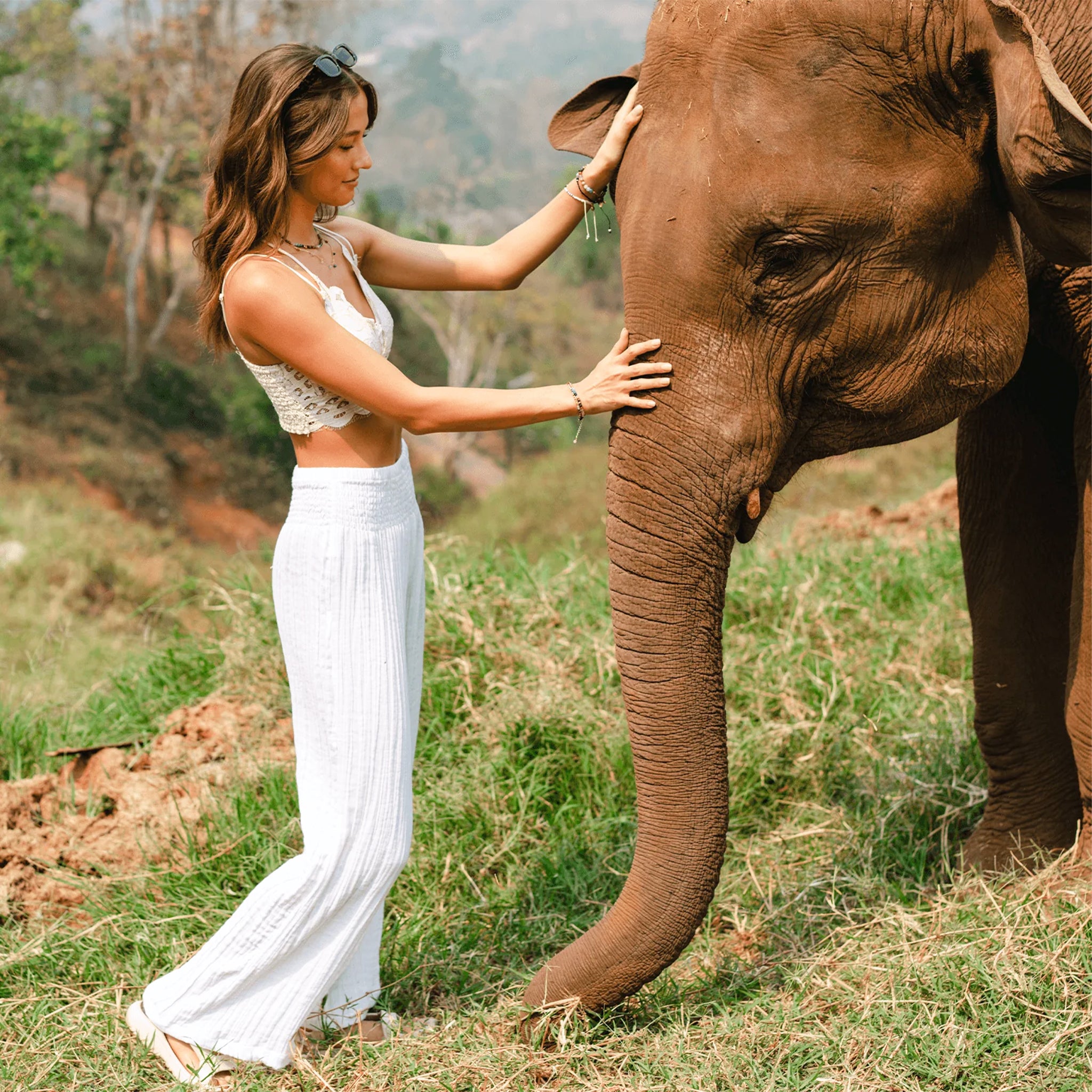A model wearing a pair of wide leg cotton pants with an elastic waistband. 